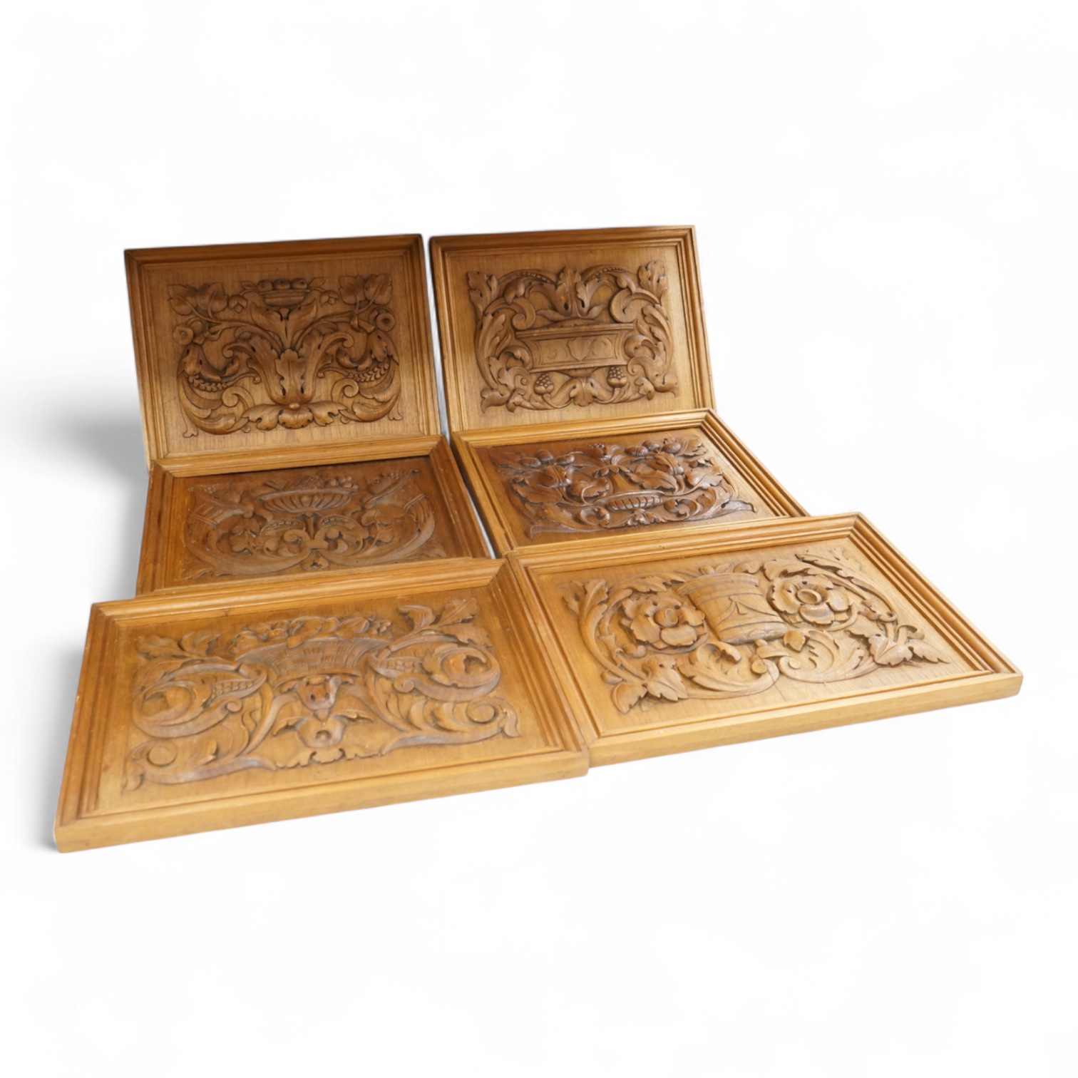 Six carved wood relief plaques, largest 31x46cm
